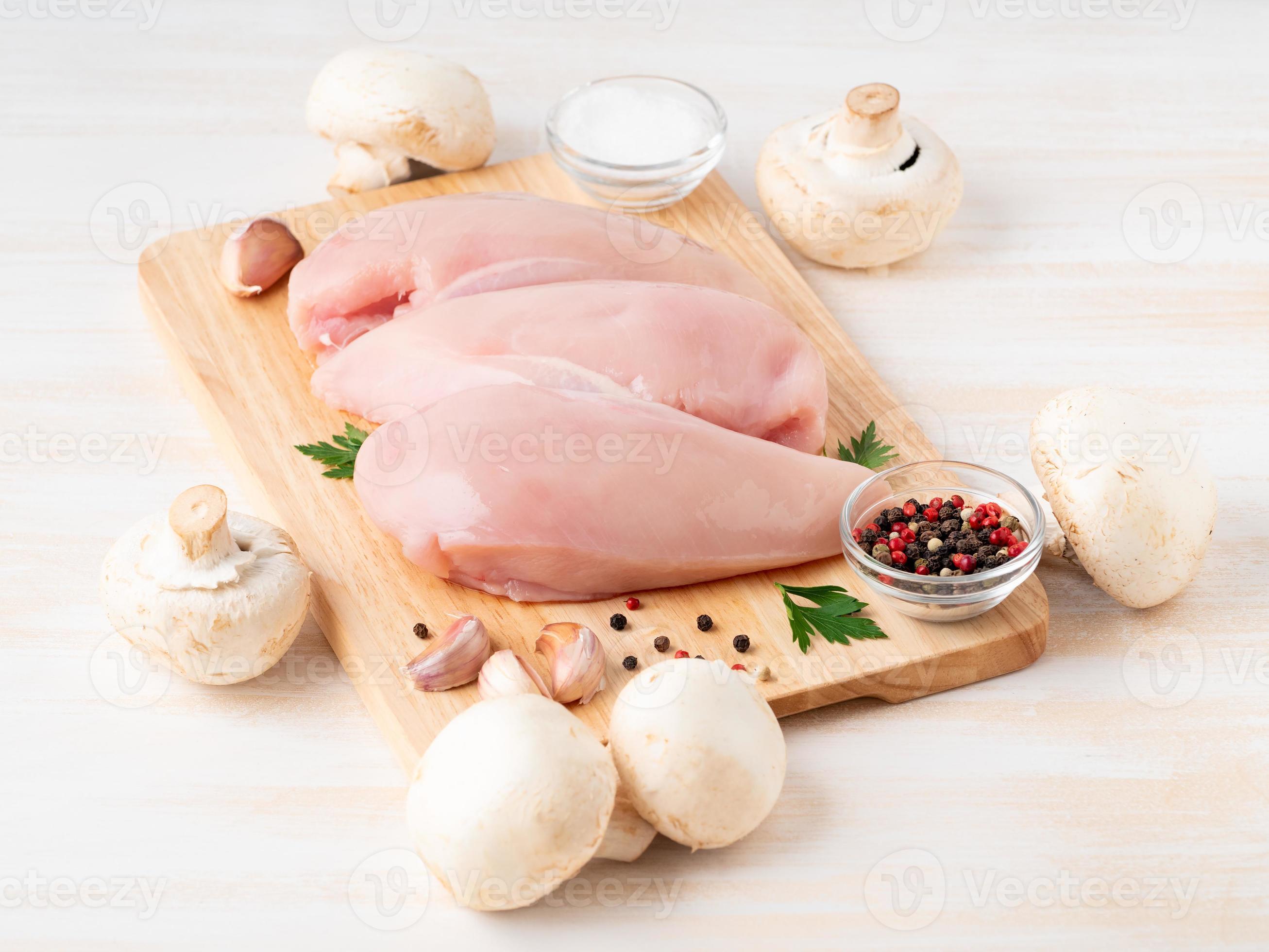 raw chicken breast fillet with spices on wooden board on white wooden table  7463202 Stock Photo at Vecteezy