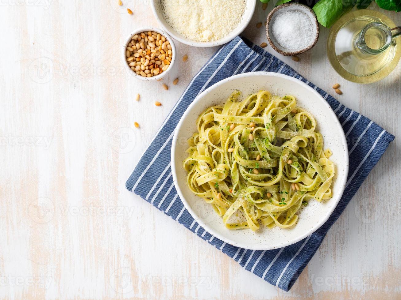 Tagliatelle pasta with pesto sauce made of Basil, garlic, pine nuts, olive oil photo