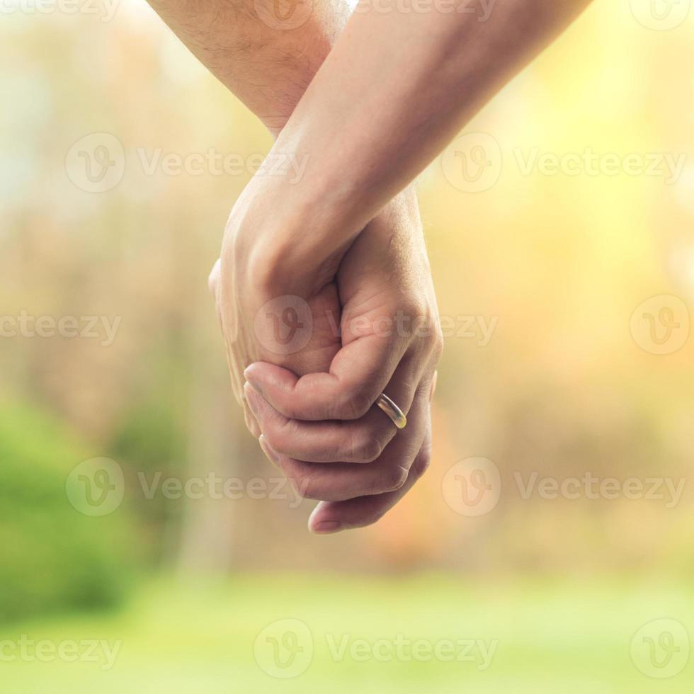 The concept of love between a man and a woman, traditional marriage, a couple holding hands photo