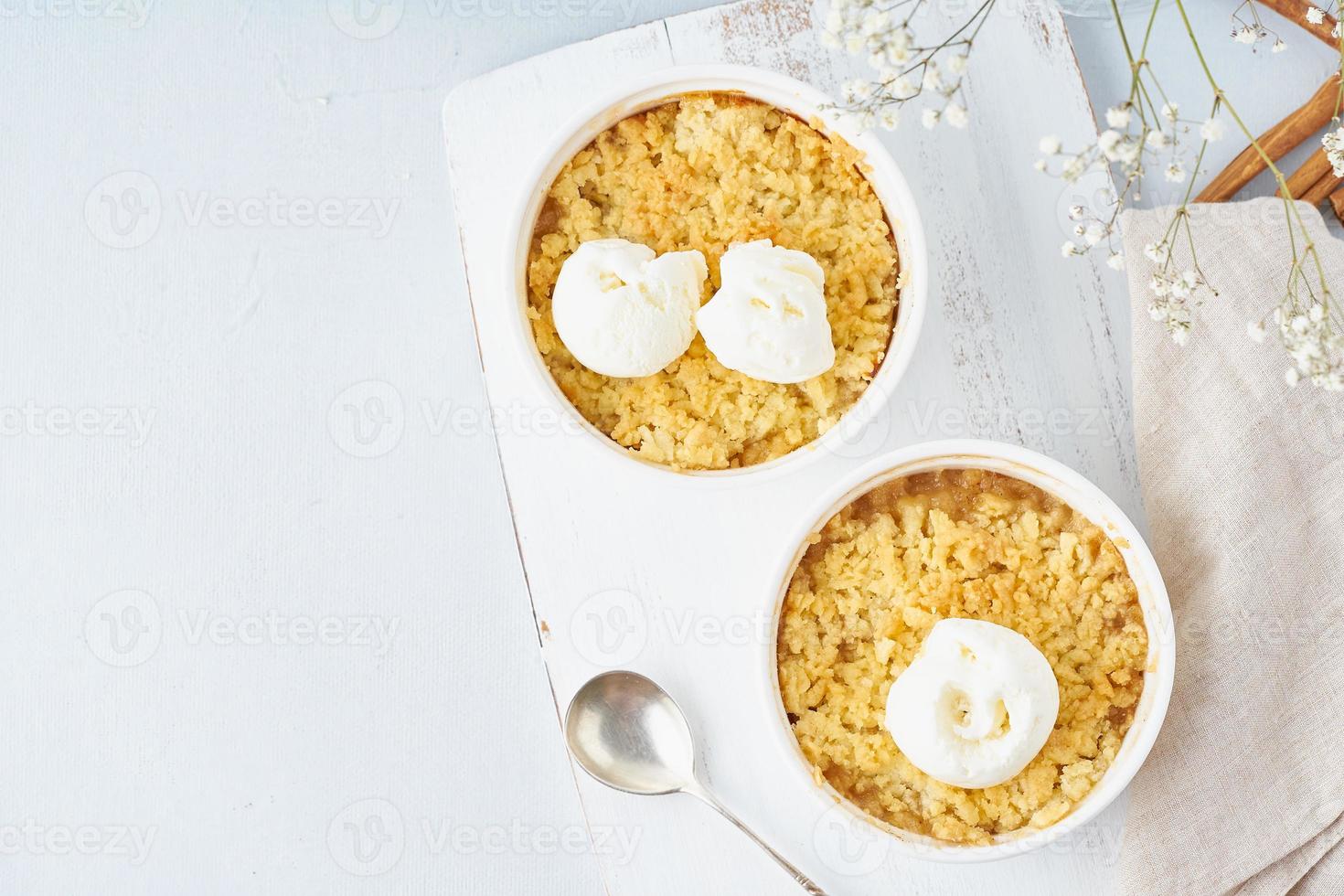 Apple crumble with ice cream, streusel. Morning breakfast on a light gray table. Top view photo