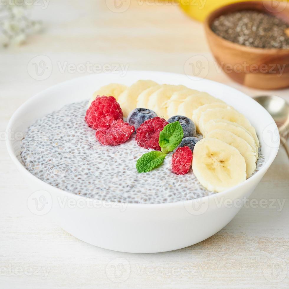 Close up Chia pudding in bowl with fresh berries raspberries, blueberries photo