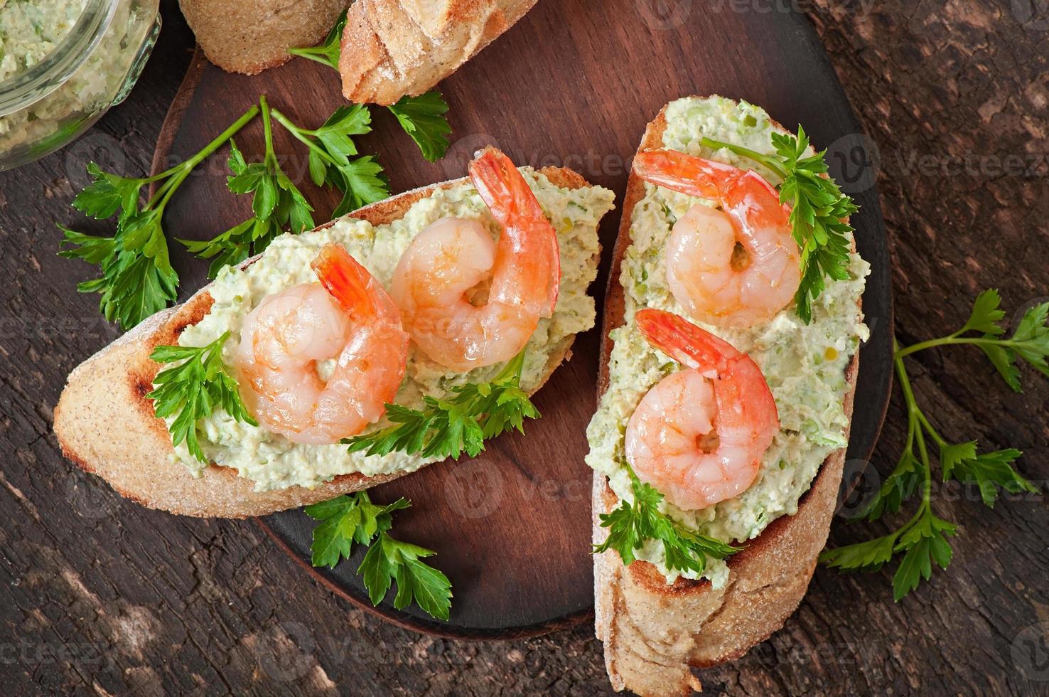 Bruschetta with a paste of green peas and shrimps photo