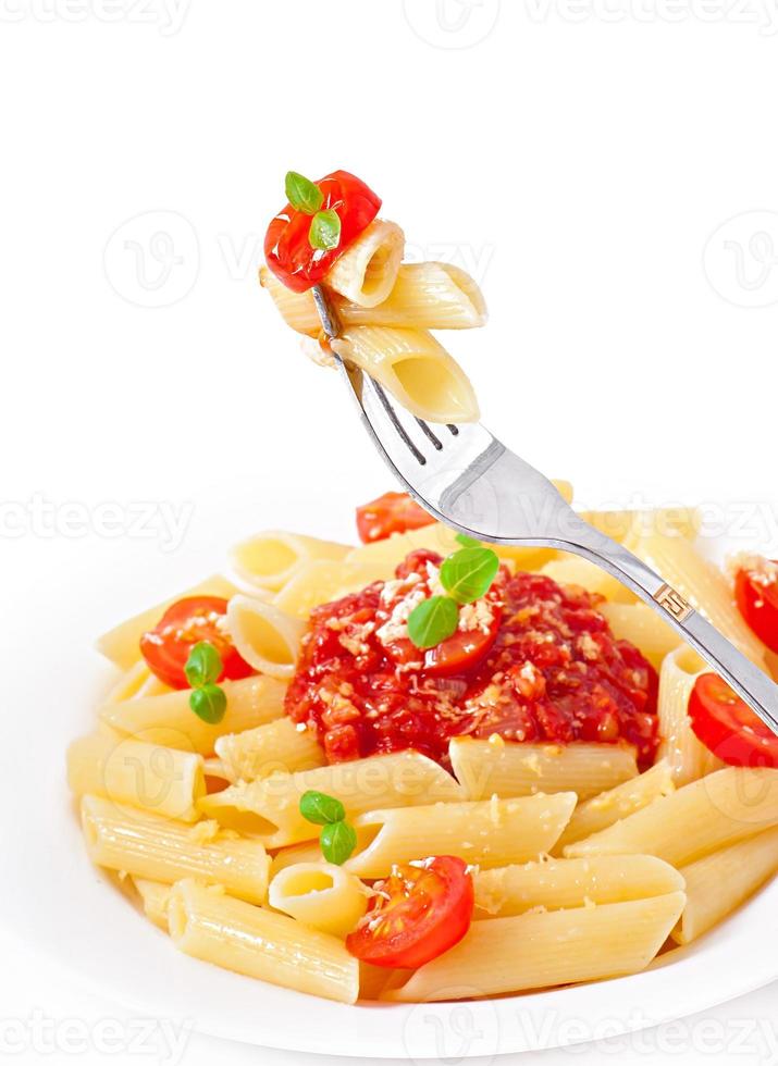 Penne pasta with bolognese sauce, parmesan cheese and basil photo