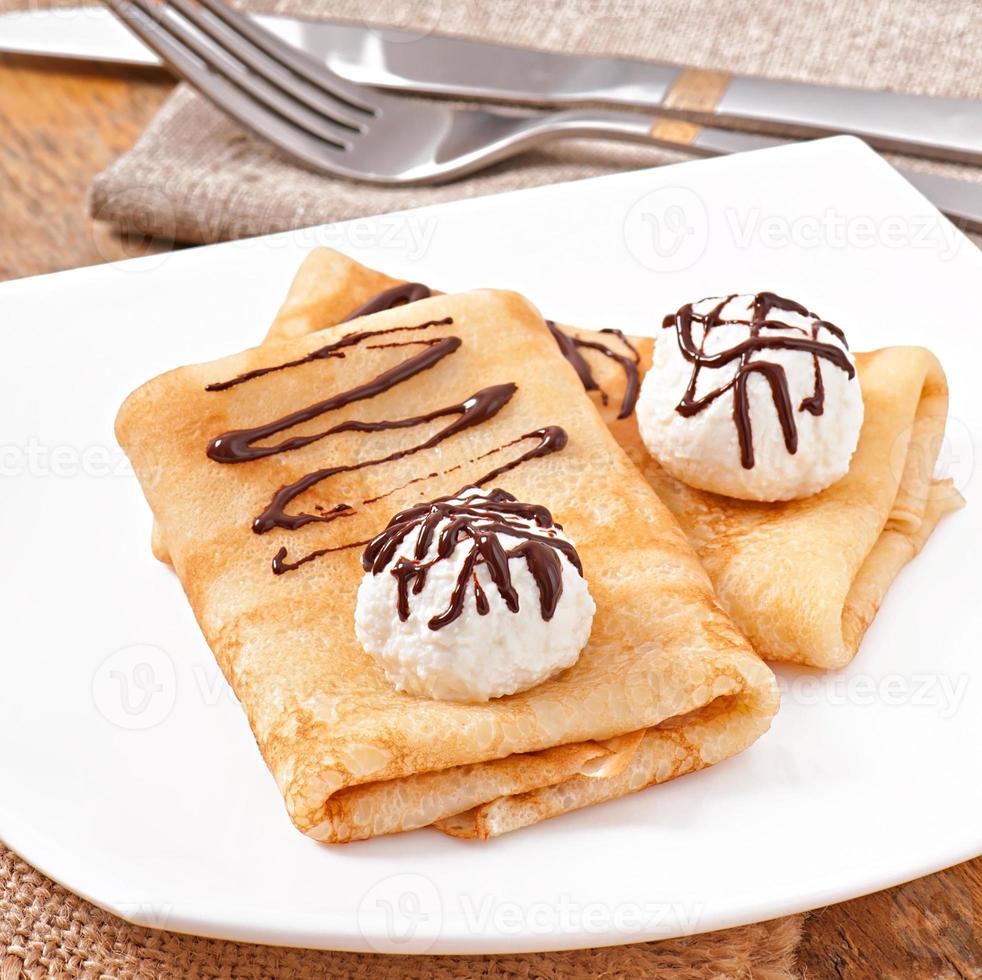 Pancakes with ice cream and chocolate sauce photo