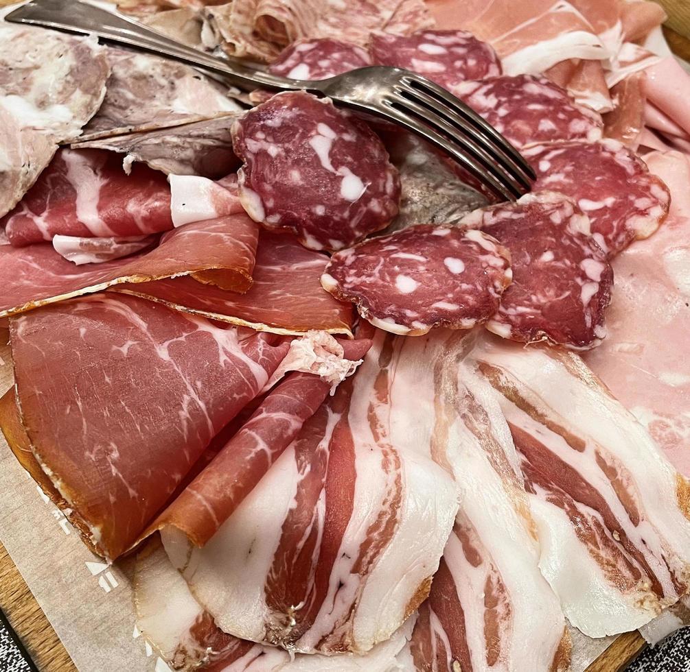 Tray with typical Italian salami. Platter of assorted cured meat. photo
