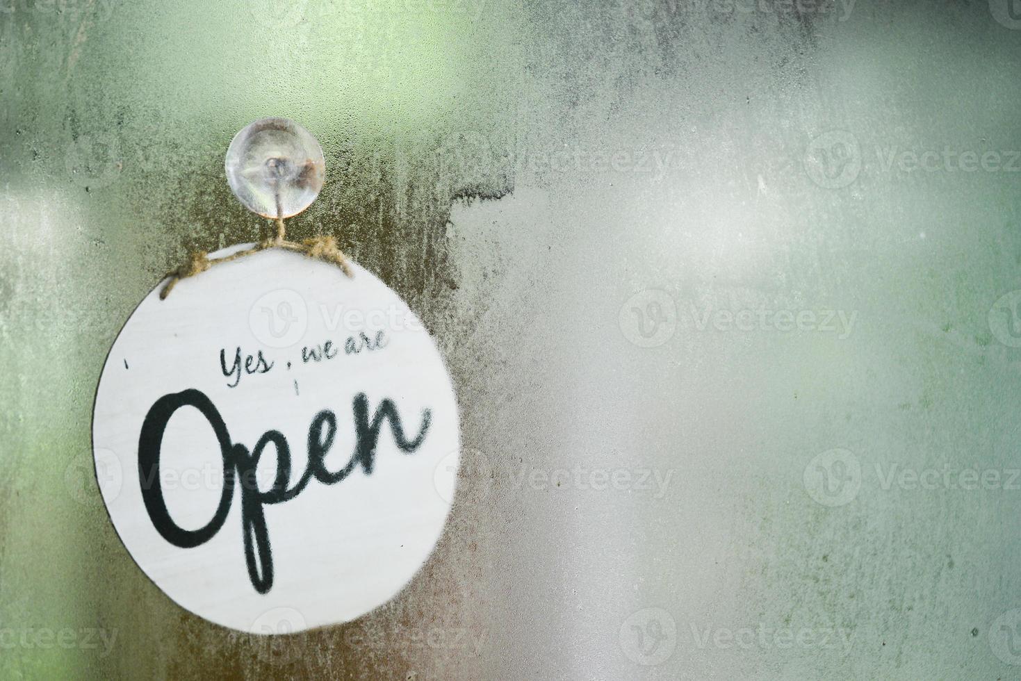 The open sign of the coffee shop in the glass room. photo