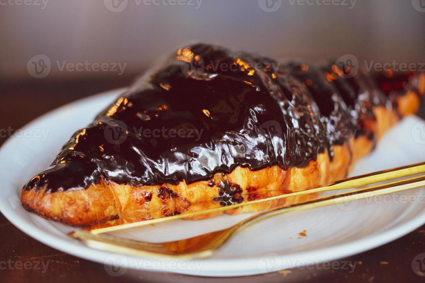 Chocolate croissant in a white plate photo