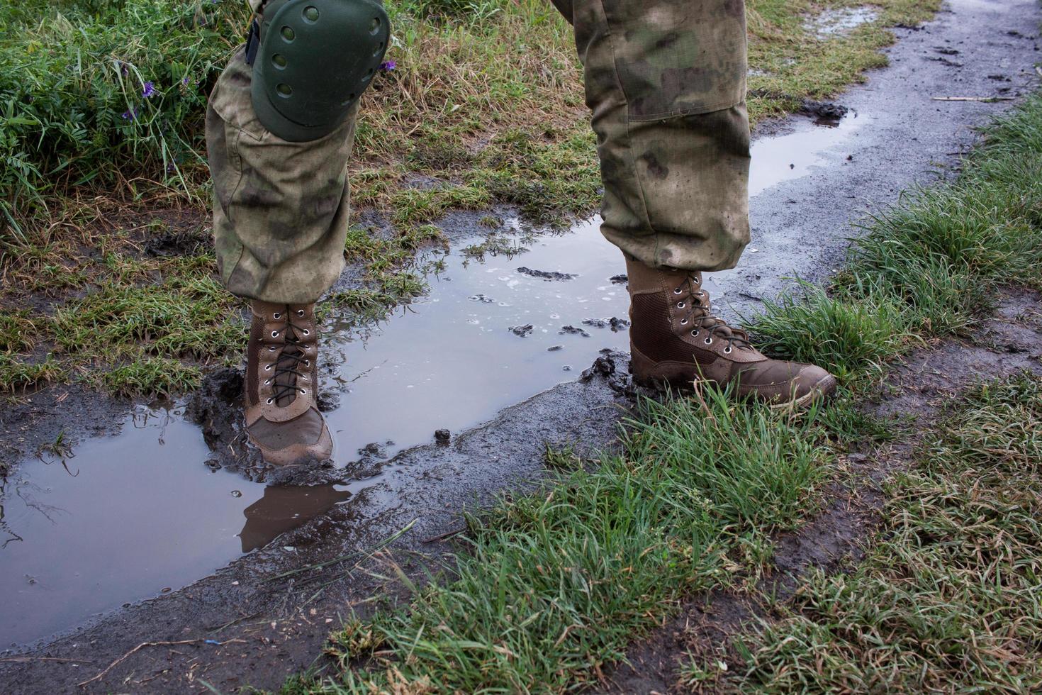 close up army boots in dirt water photo