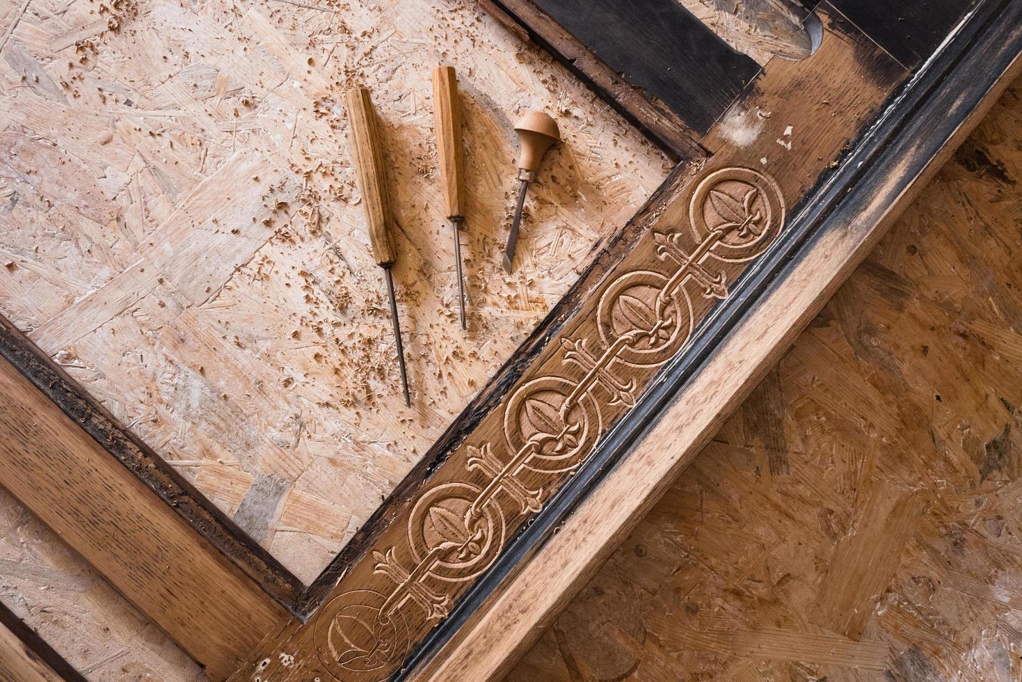 Woodcarving workshop, close up picture of tools and wood photo