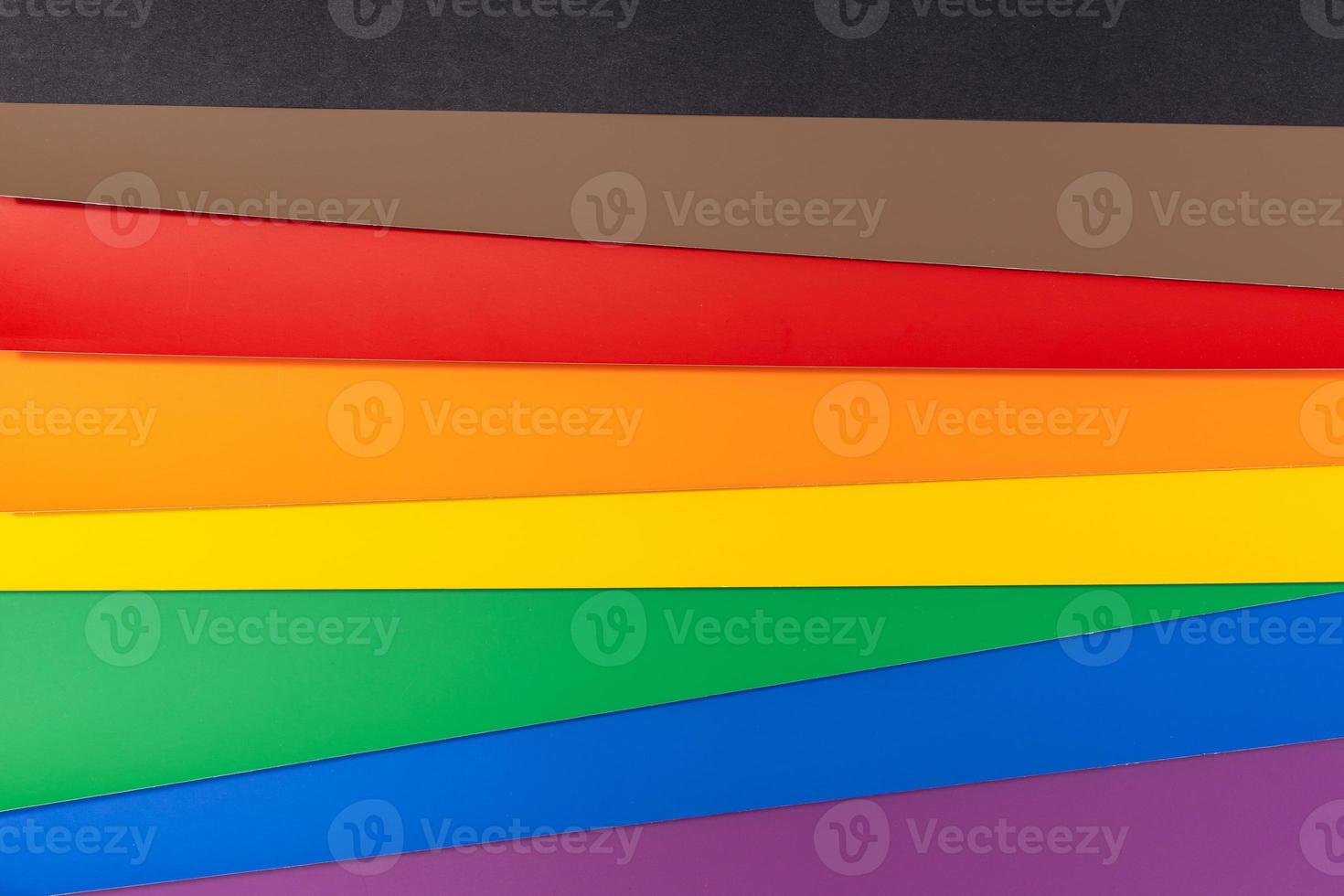 New LGBT Rainbow flag background with black and brown stripes. Group of colored cardboard. Gay pride flag photo