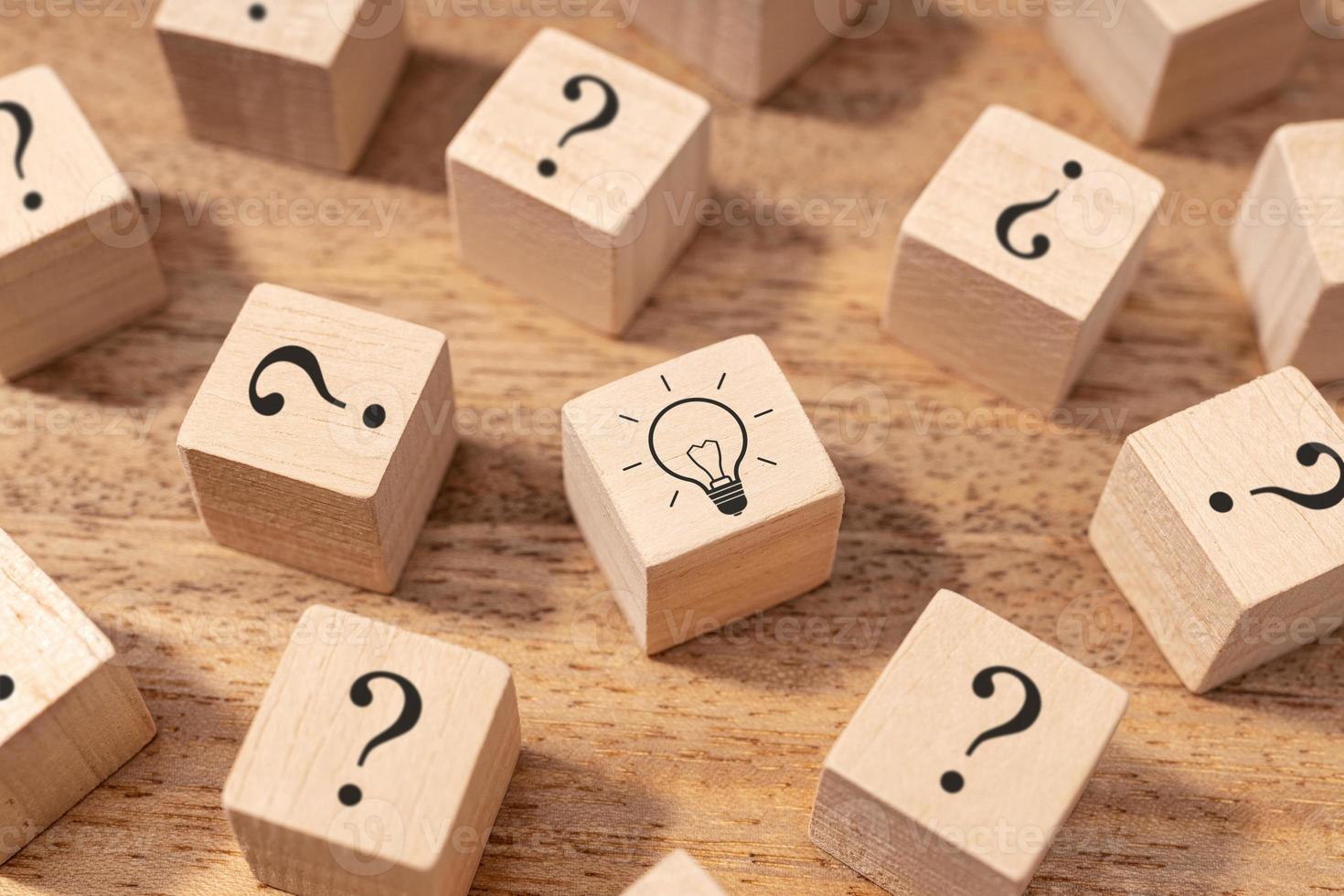 Creative idea and innovation concept. Wooden blocks with question mark symbol and light bulb photo