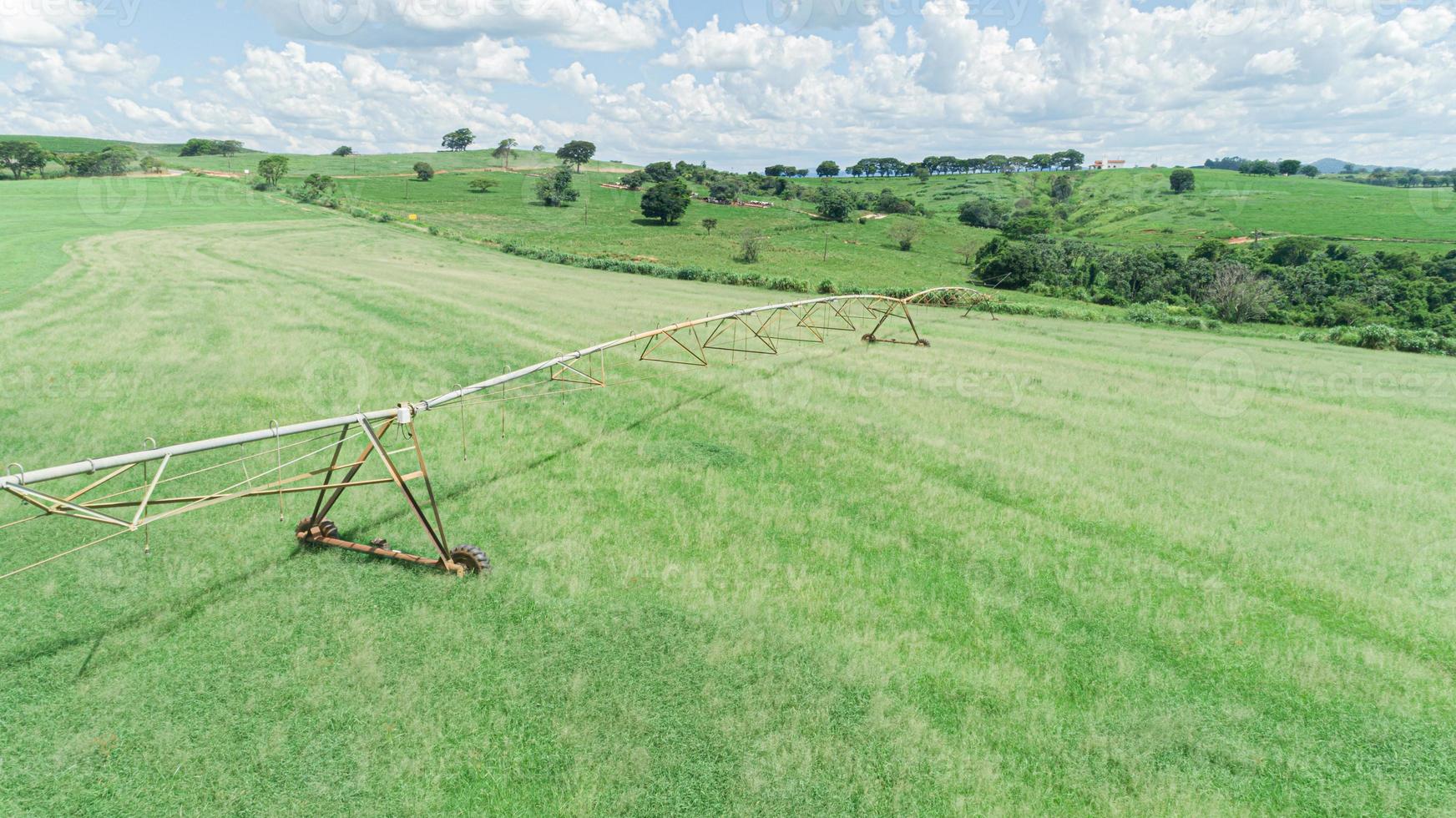 Agricultural irrigation system on sunny summer day. An aerial view of a center pivot sprinkler system. photo