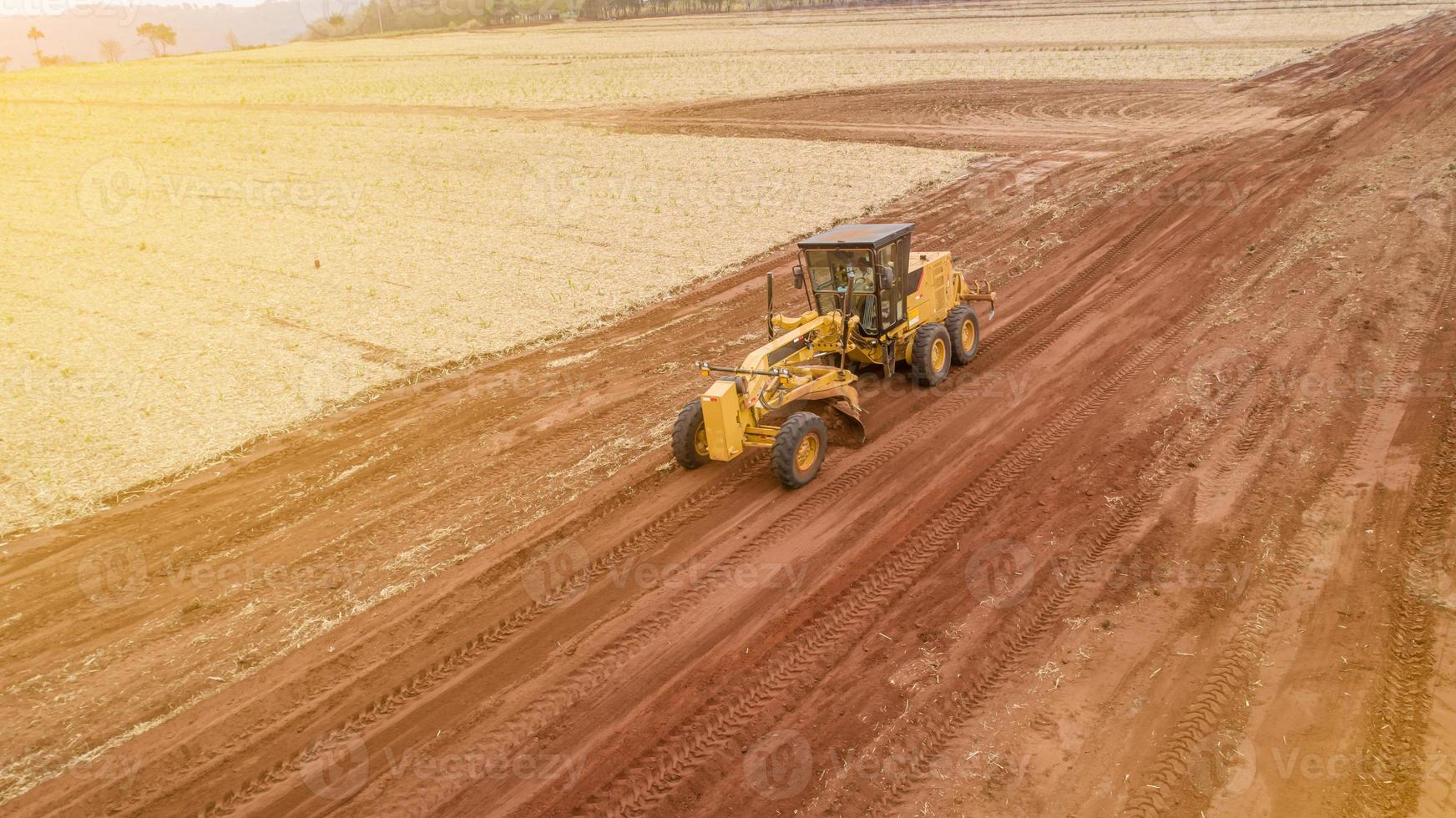 Tractor and plowing the ground for a future plantation. Tractor plowing and preparing the soil. photo