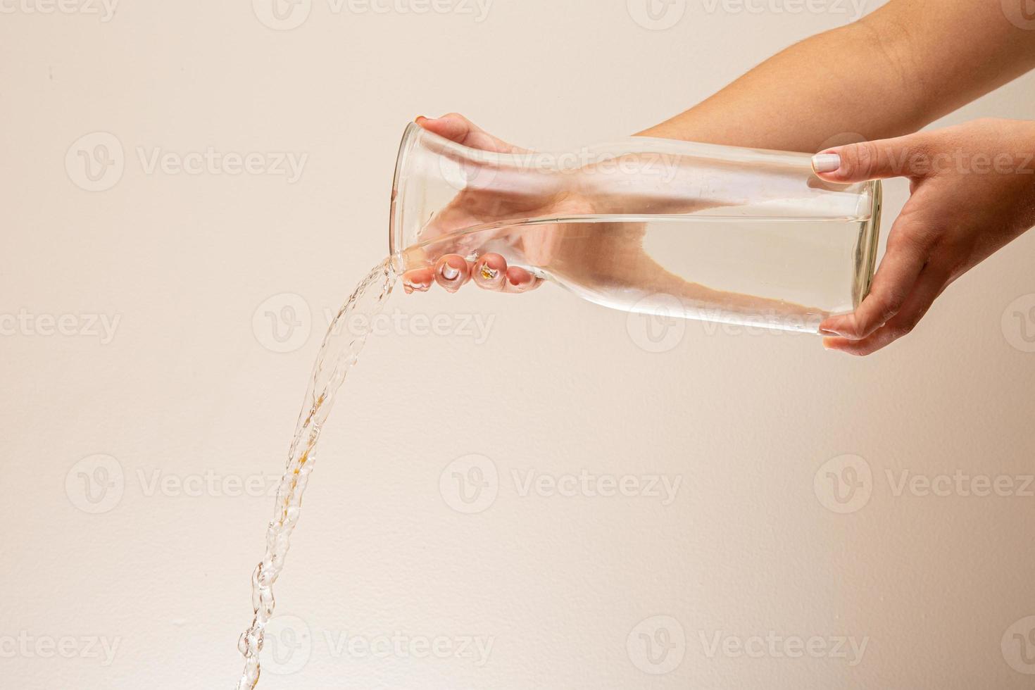 Water Pour into Glass. Water pouring. Splashing water on white background. photo
