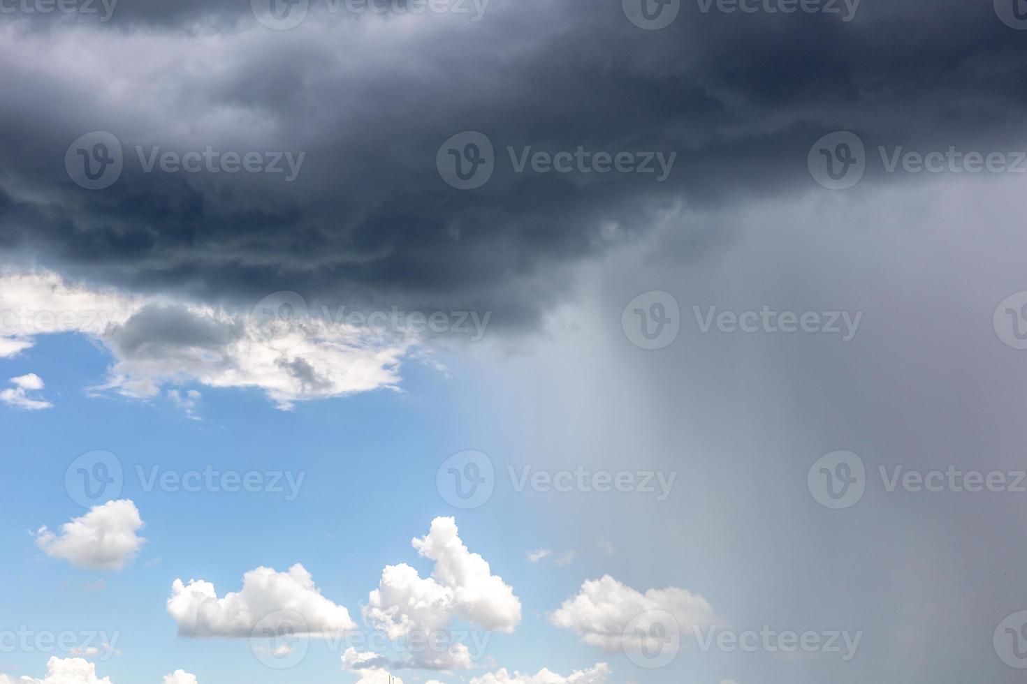 Rain cloud. Weather change. Different climatic situations in a single image. photo