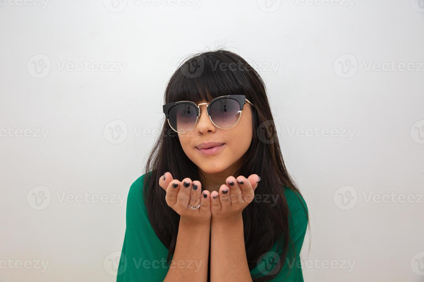 Young woman sending kisses with hands photo