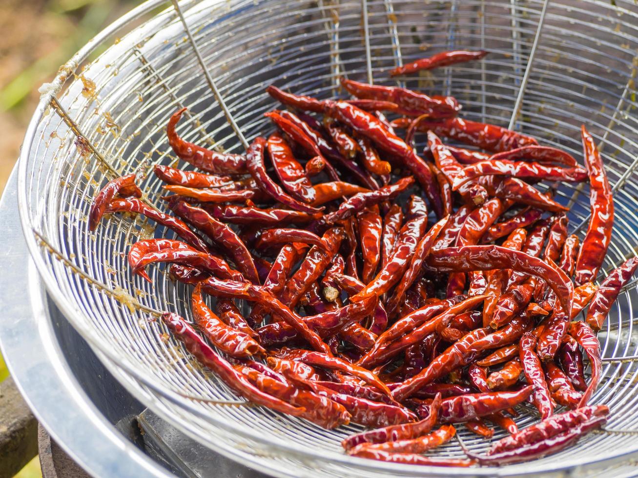 Dried chilies fry on colander photo
