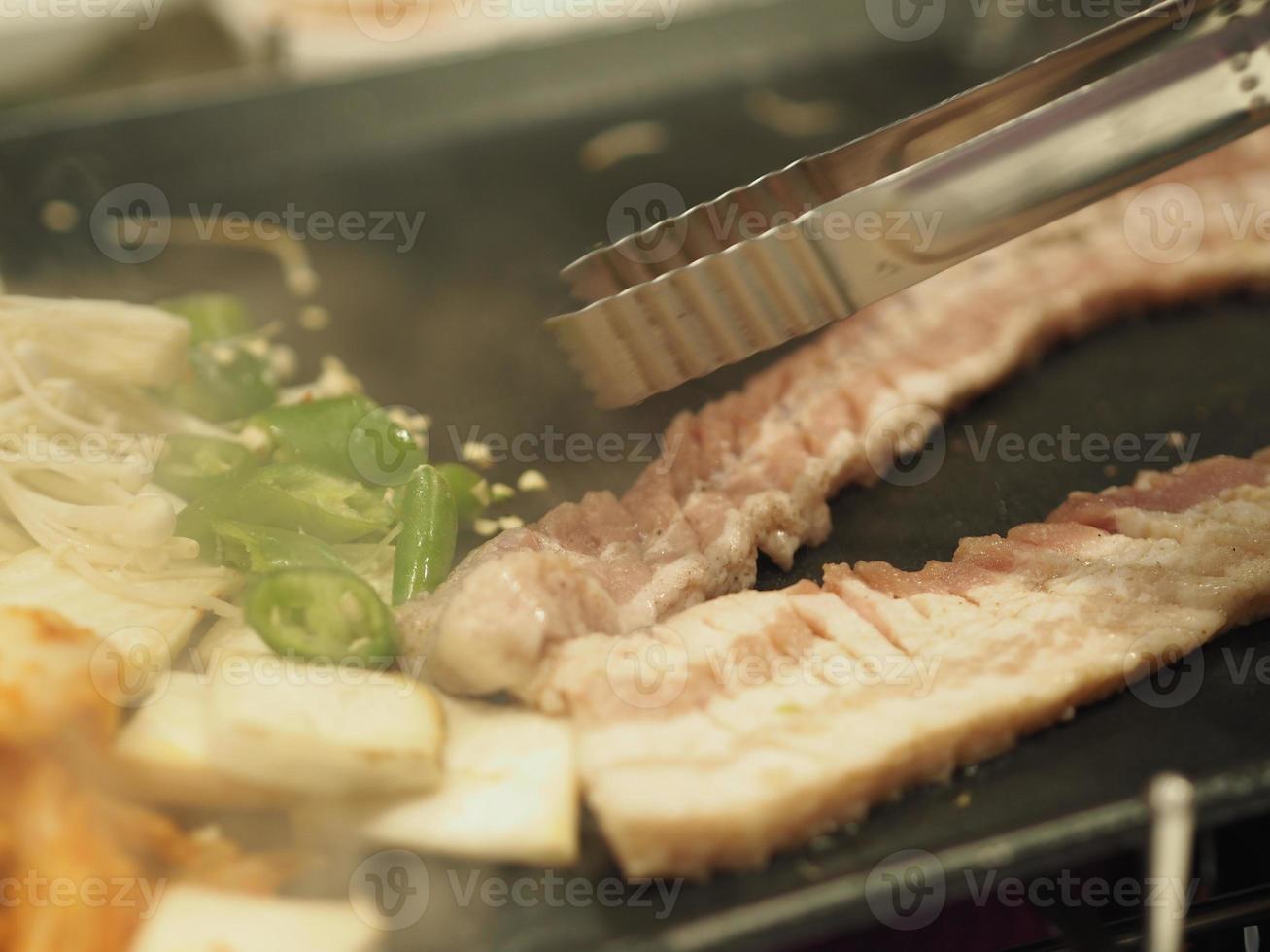 grilled pork is on the pan in Thai style, Thai buffet with pork, chicken and other meats, cooked on brass barbecue pan, pork griThai Barbecue Buffet, Thai BBQ buffet,food PORK photo
