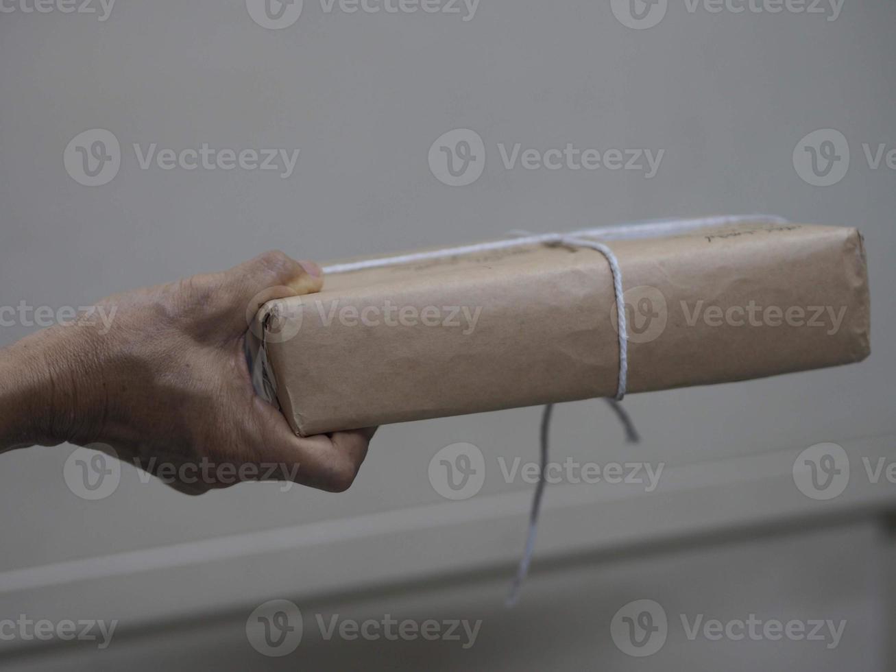 woman with a packages brown paper box in her hand photo