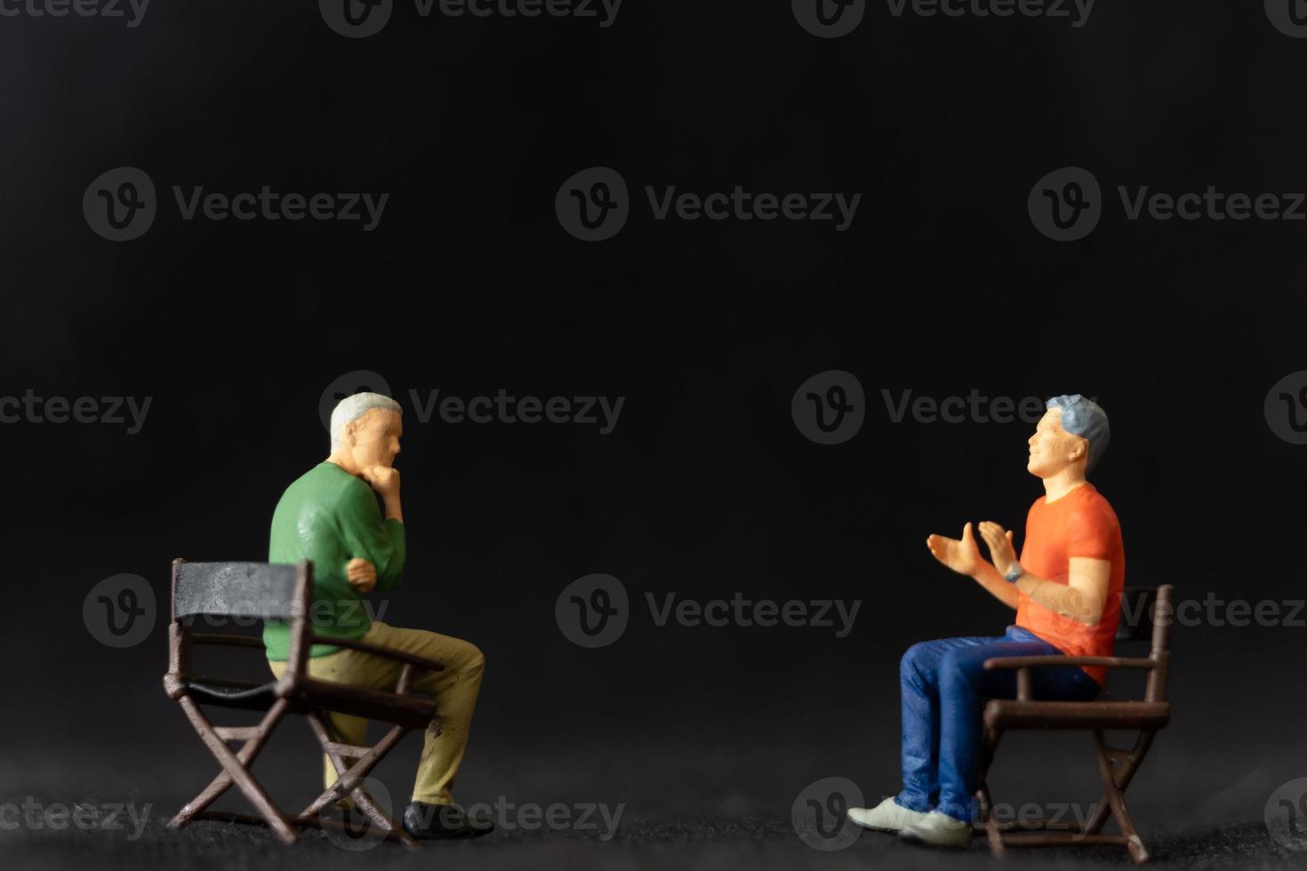 Miniature people Therapist and patient talking together photo