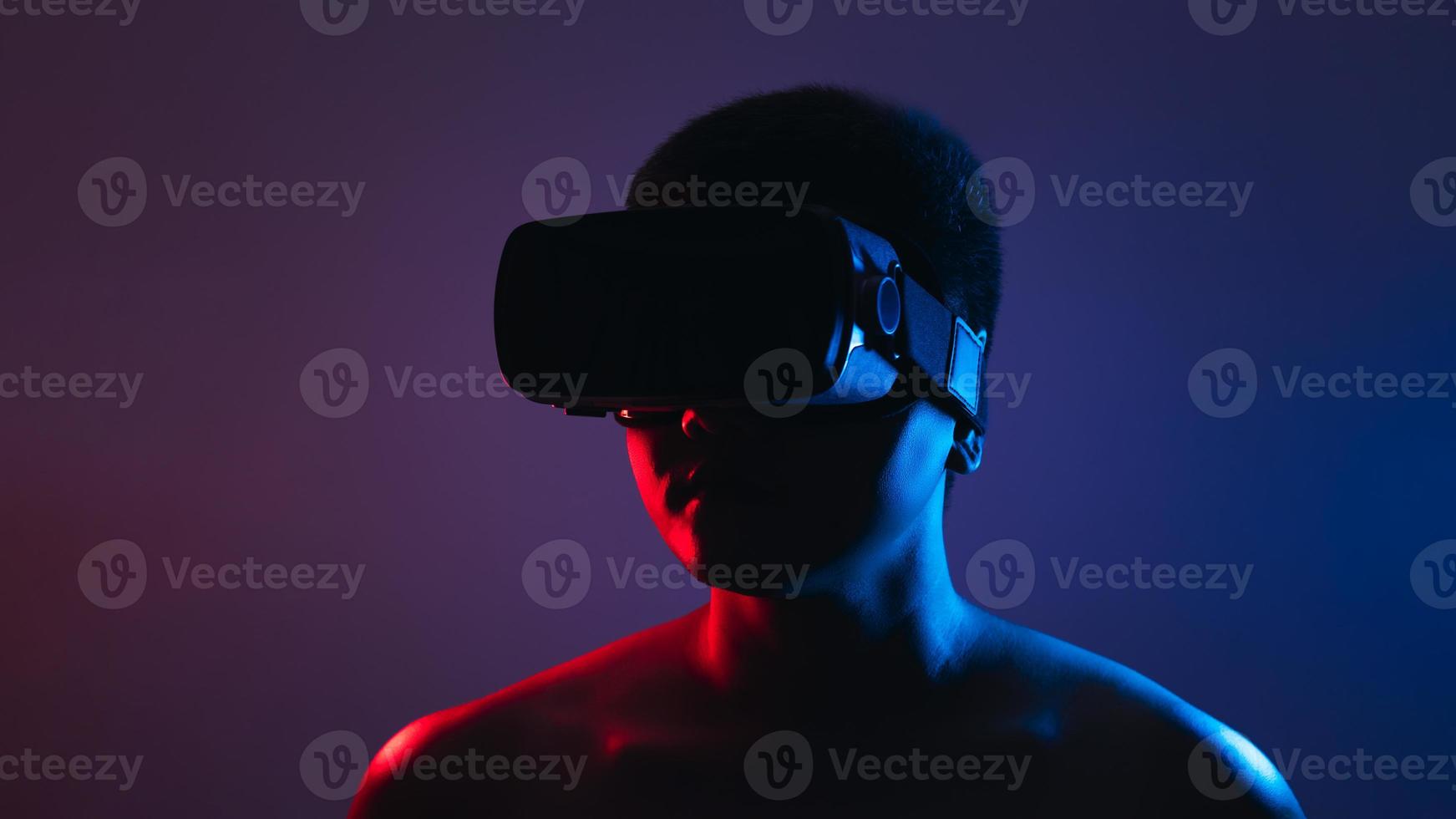 Young man wearing VR goggles. Metaverse technology virtual reality concept. Virtual Reality Device, Simulation, 3D, AR, VR, Innovation and Technology of the Future on Social Media. photo