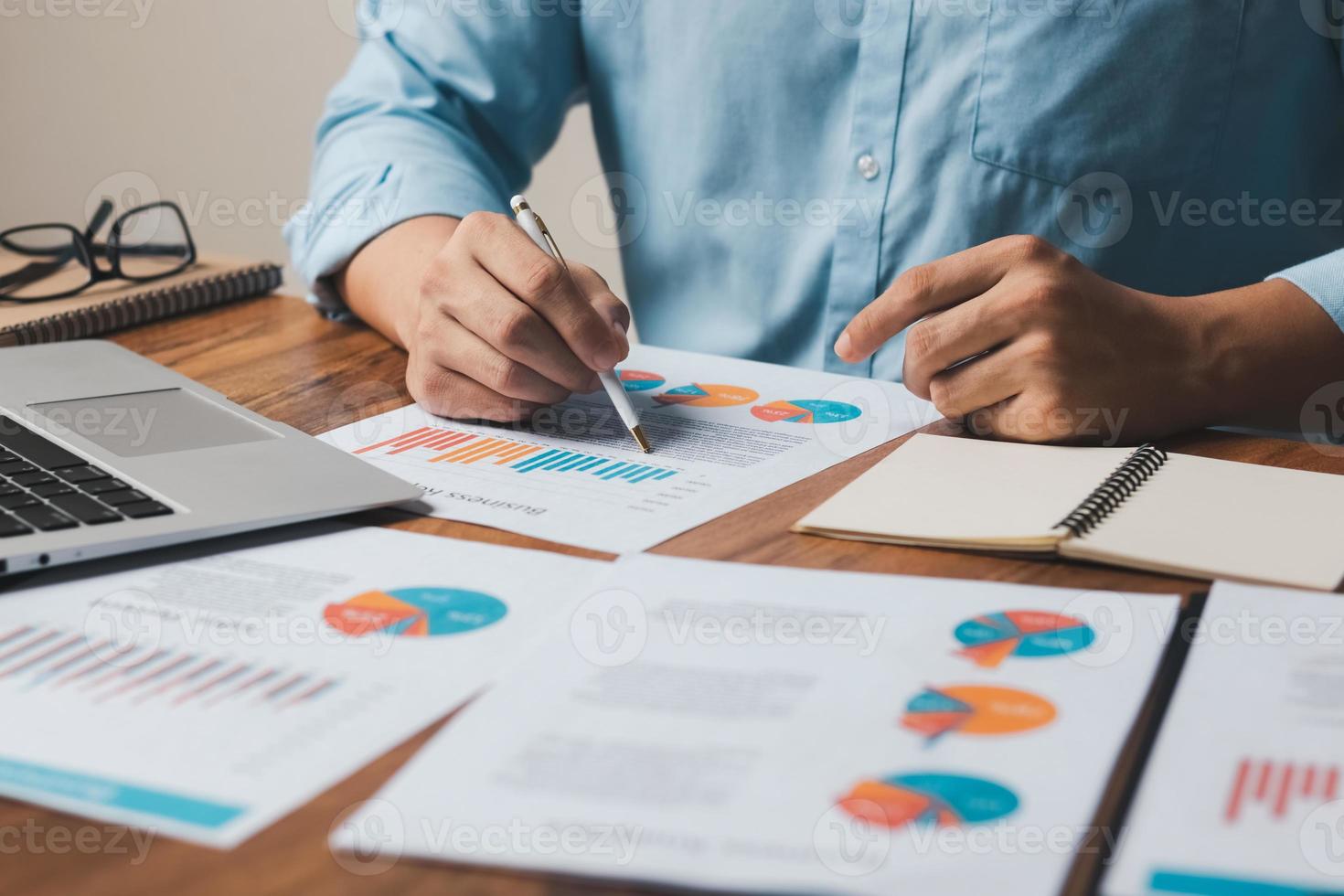 accounting concept. businessman working using a laptop with analyzing finance sales data and economic growth graph chart. photo