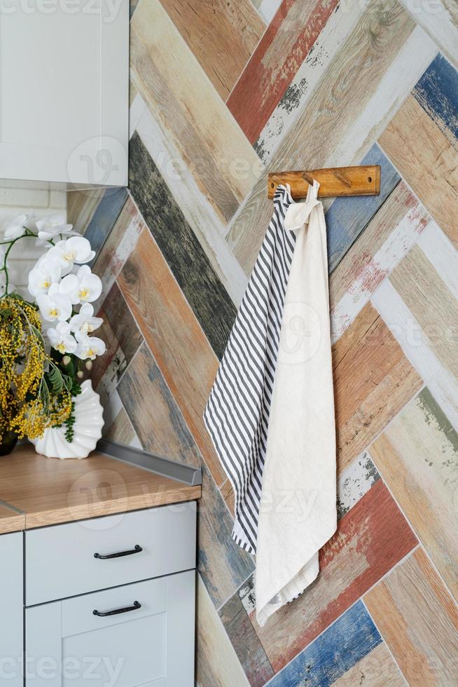 Interior of kitchen in rustic style with towels on hanger photo