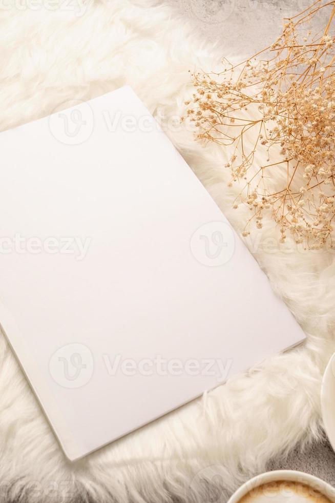 blank calendar mockup with carrot cake dessert, coffee and flowers on white rug photo