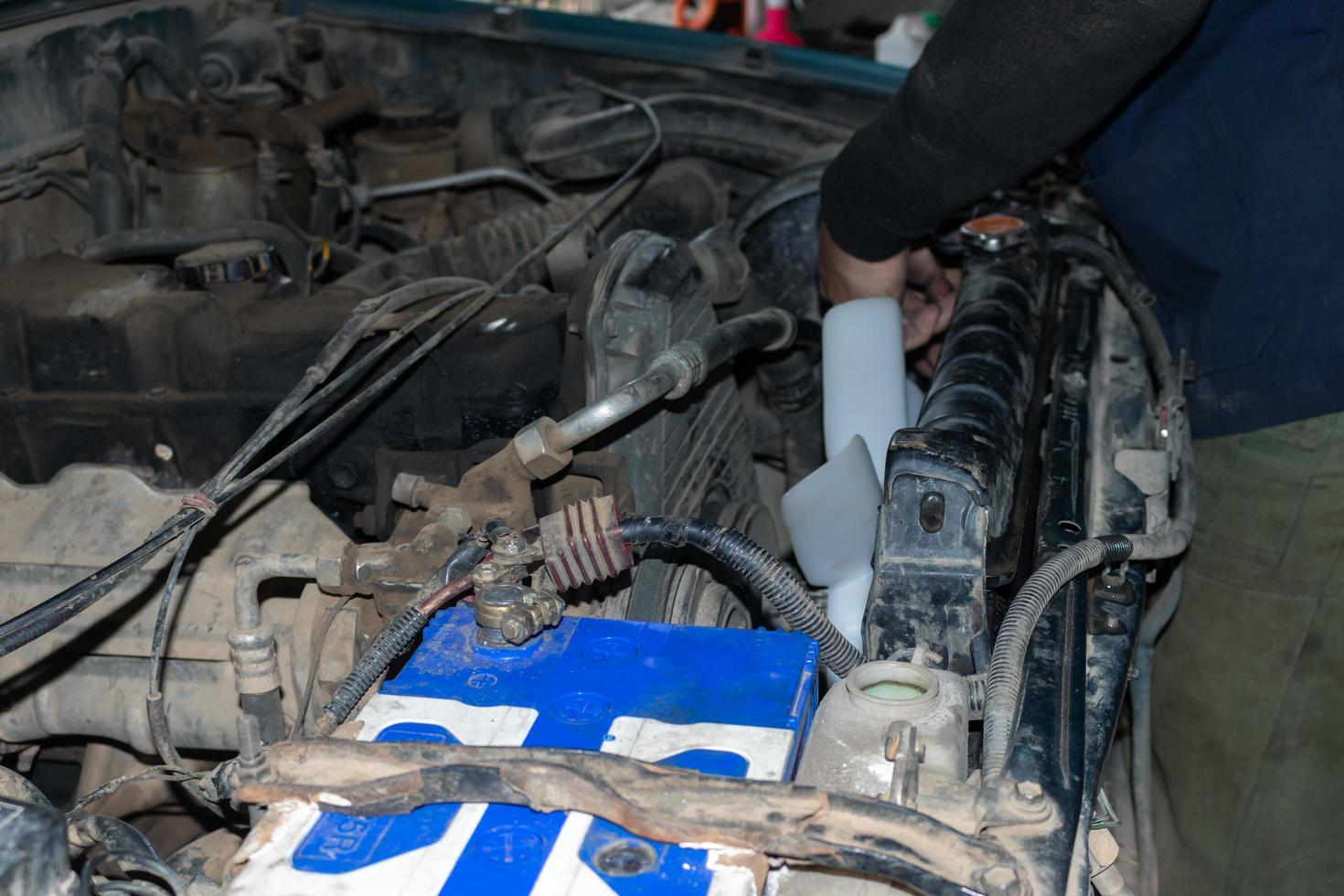 The mechanic is checking the engine. photo