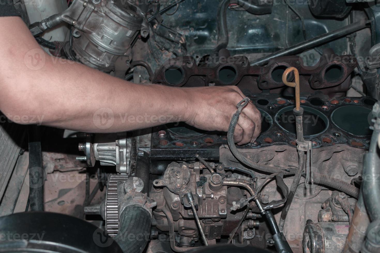 The mechanic is checking the engine. photo