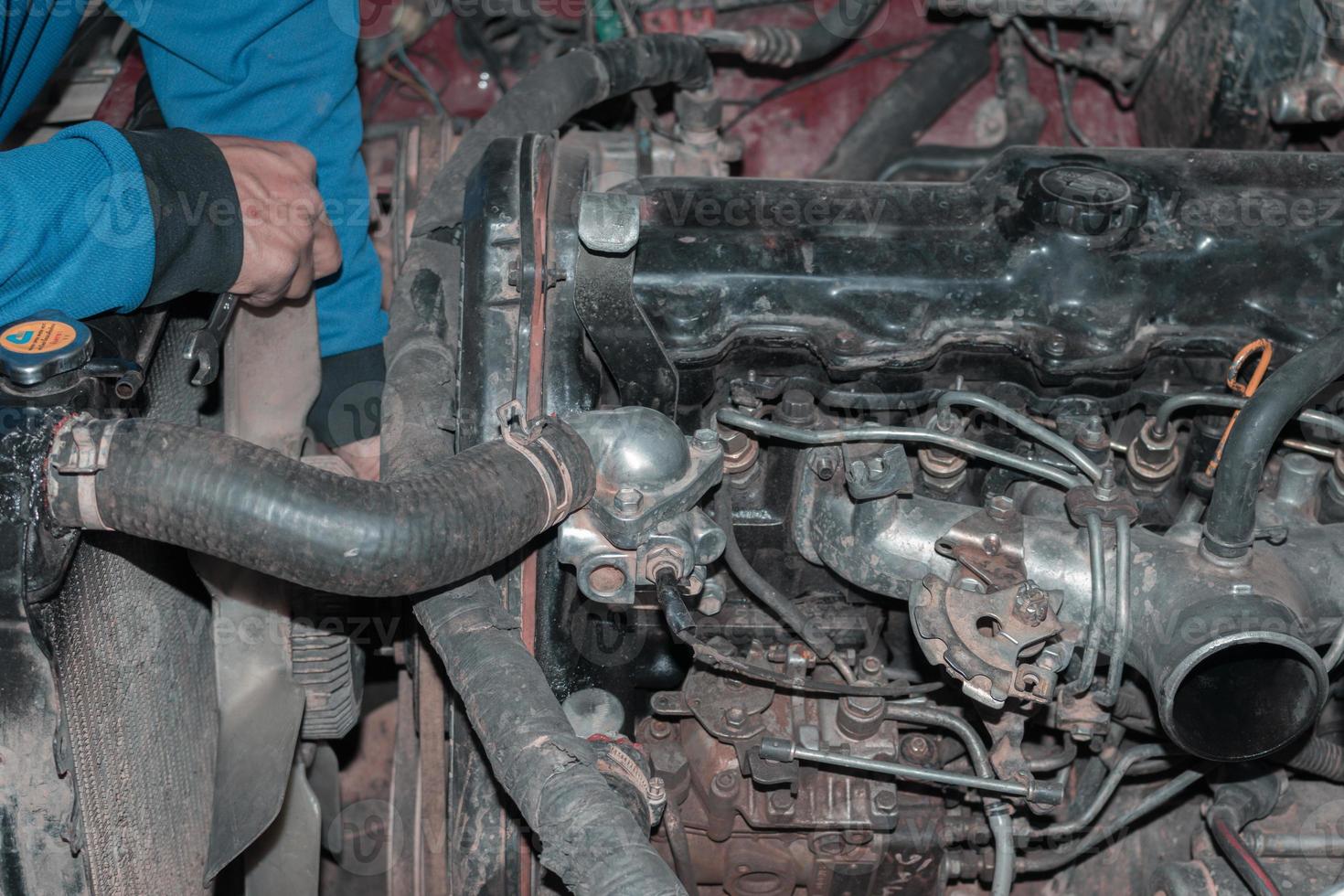 The mechanic is checking the engine. photo