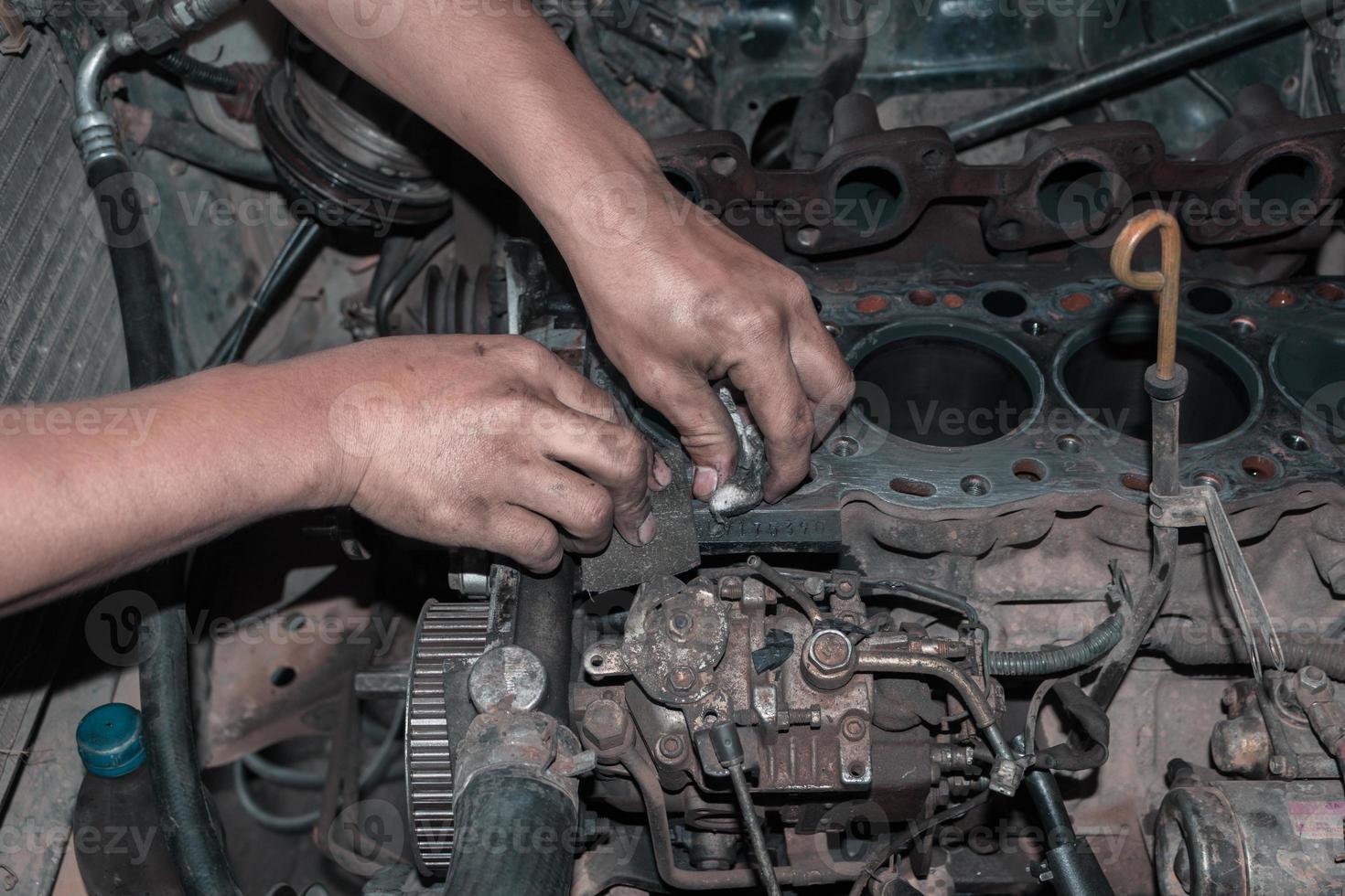 The mechanic is checking the engine. photo
