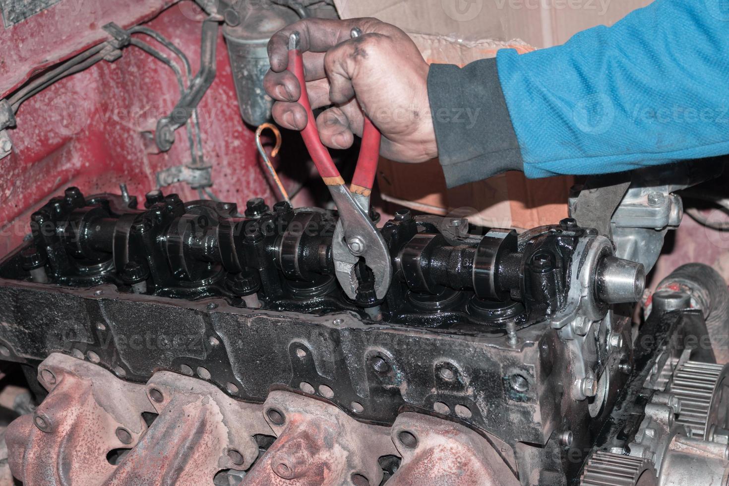 The mechanic is checking the engine. photo