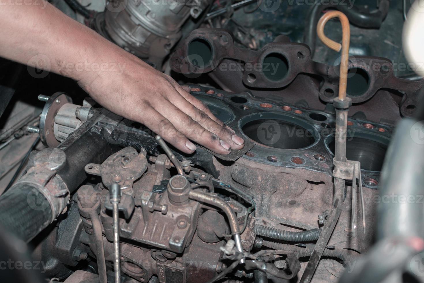 The mechanic is checking the engine. photo