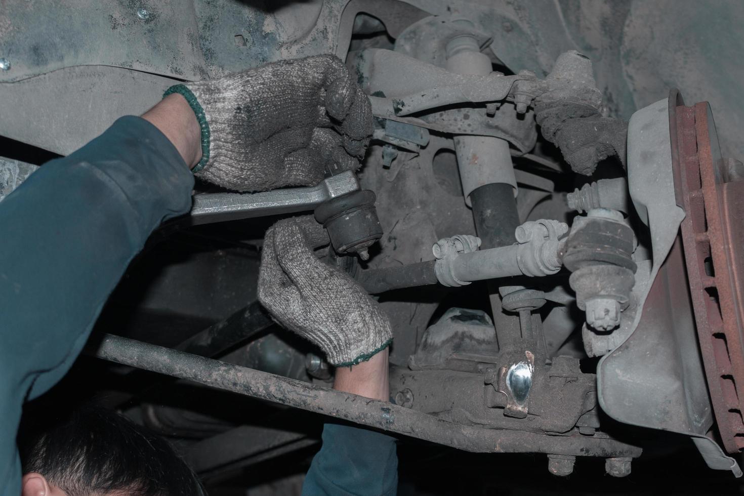 The mechanic is checking the engine. photo