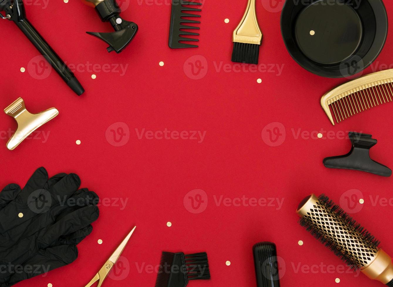 Hairdressing tools on a red background. Holiday template with space for text in the center. photo