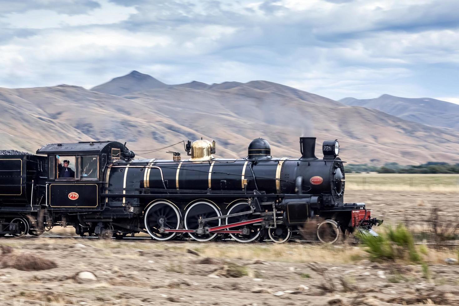 KINGSTON, NEAR LAKE WAKATIPU, NEW ZEALAND, 2012. Kingston Flyer steaming across the plain photo