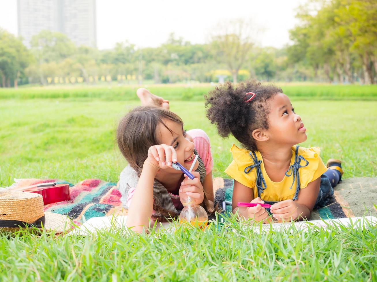 A group of young children of many nationalities play and learn outside of school photo