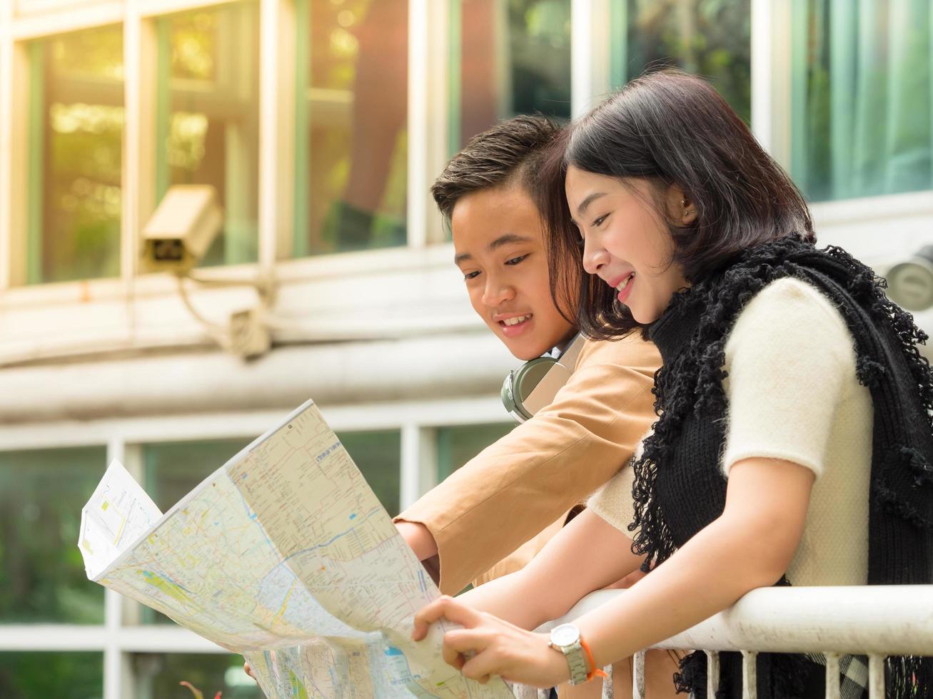 Young boy and girl are looking for information on a map for travel photo