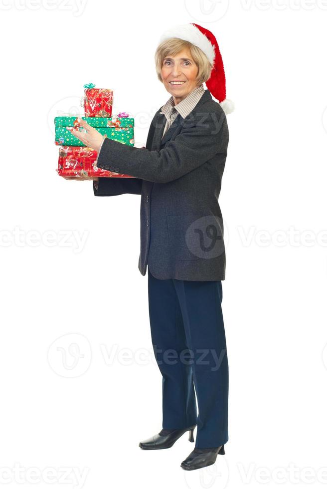Senior business woman hold Christmas presents photo