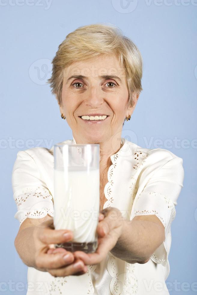 Healthy senior woman with milk glass photo