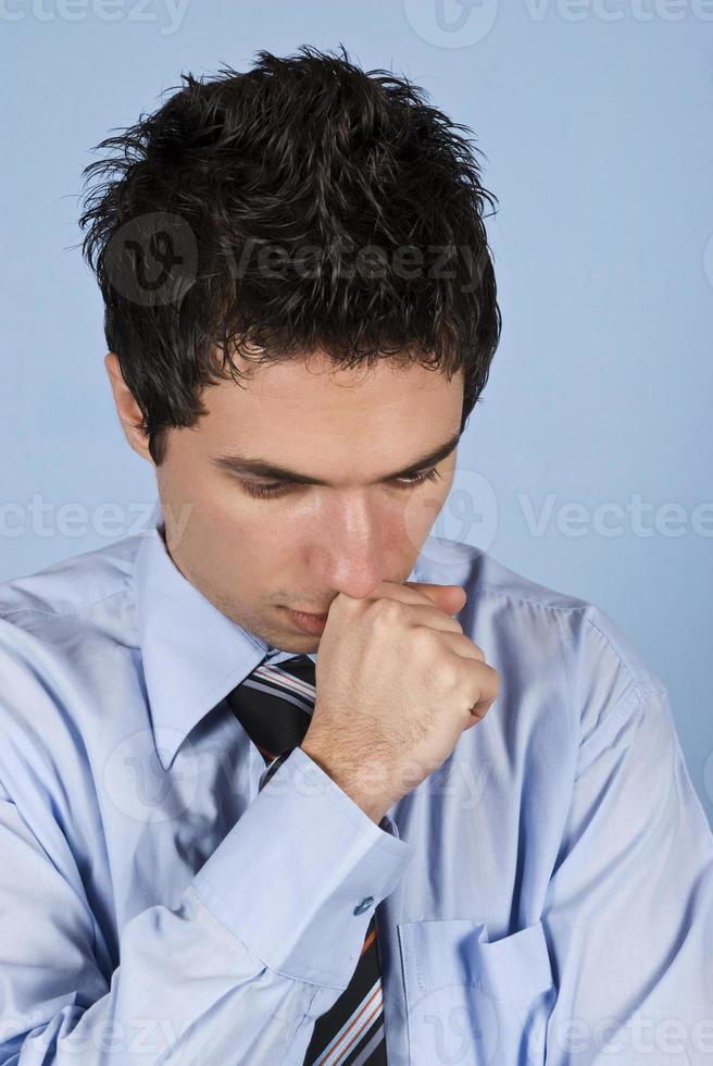 Sad businessman on blue background photo