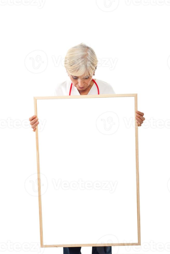 Senior woman holding  blank poster photo