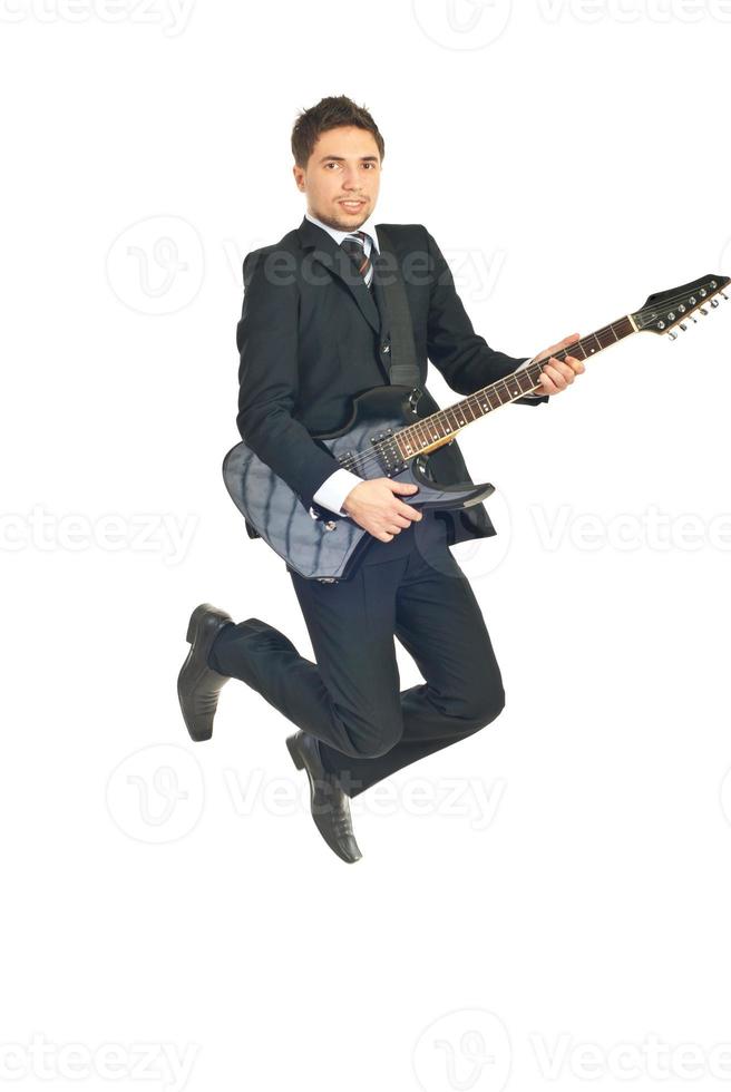 Business man jumping with guitar photo