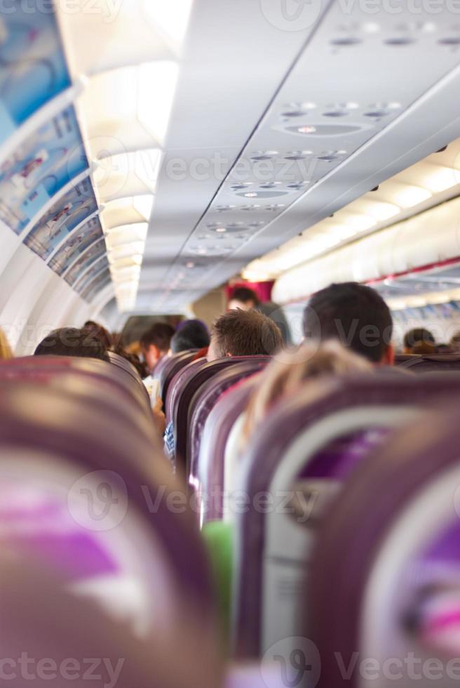 Passagers on chairs in airplane photo