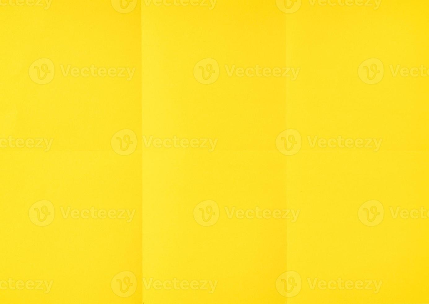 Yellow crumpled unfolded paper sheet texture background. Paper folded in six. Full frame photo