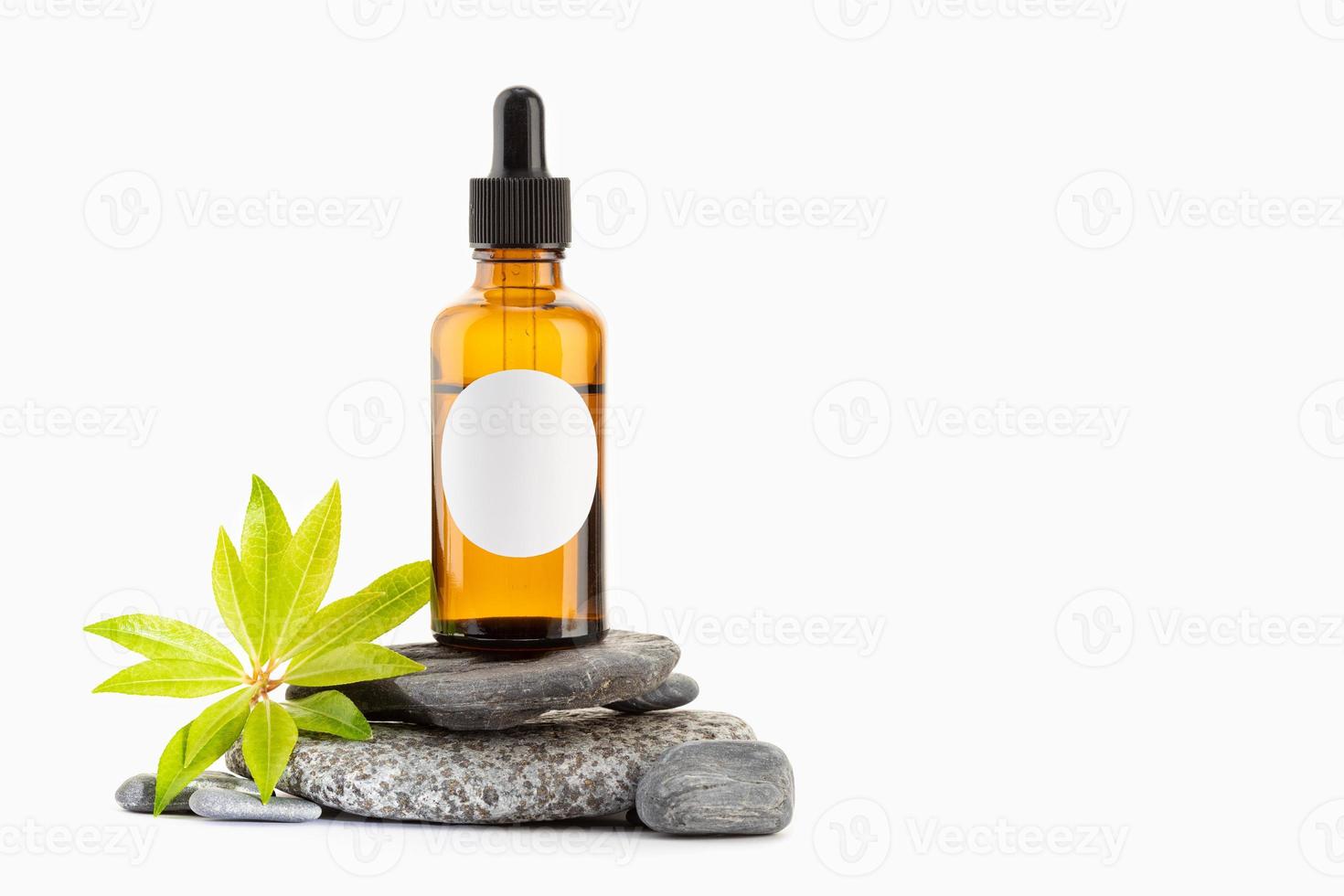 Herbal Essential oil on amber bottle with blank label isolated on white background. Template Mock up. Copy space photo