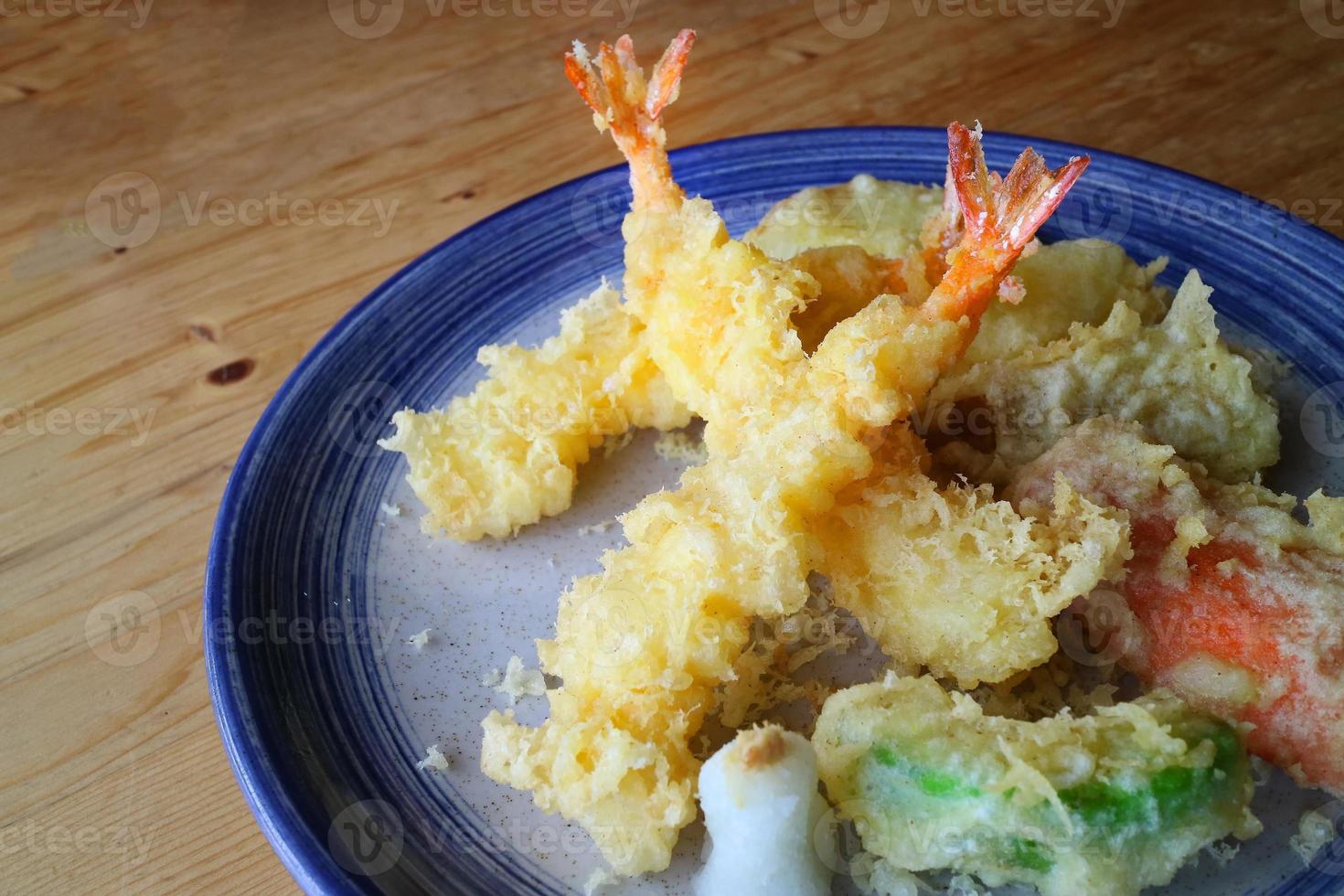 Japanese tempura with fresh vegetables deep fried and shrimp serve on ceramic round plate. Japanese traditional food photo