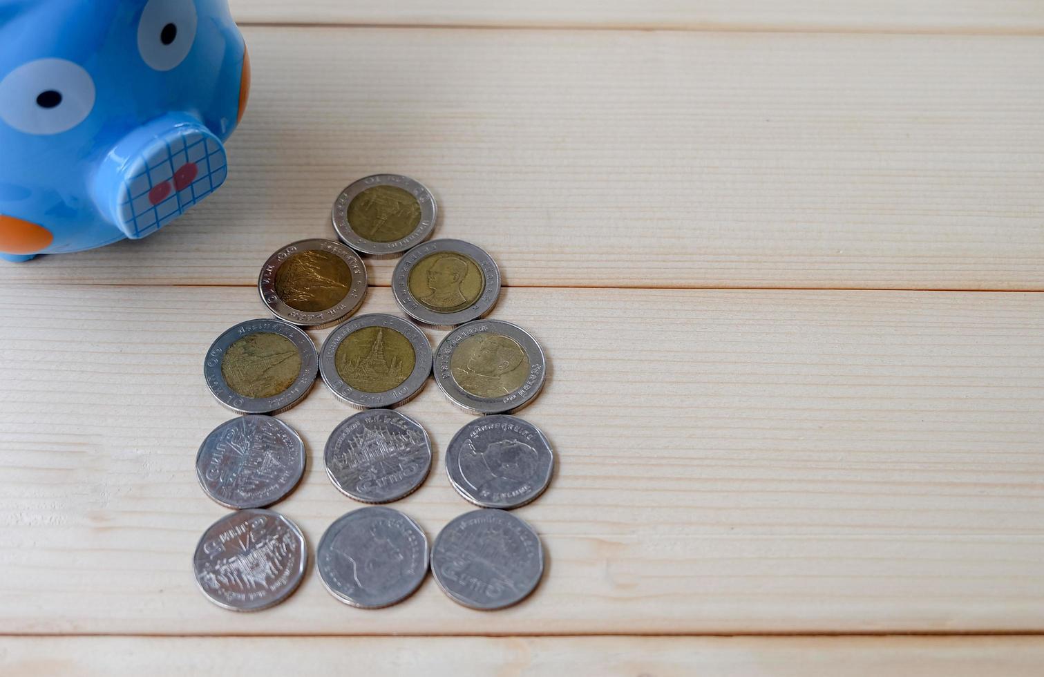 Top view and close up of A piggy bank and many coins in house shape. Saving money for buy house in the future concept. photo