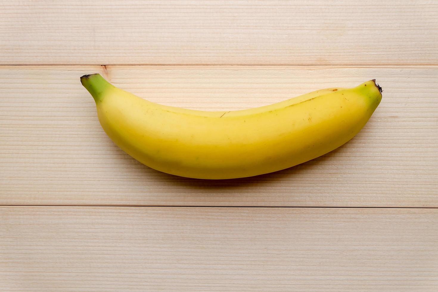 Top view and close up of Fresh sweet yellow banana on wooden background. photo